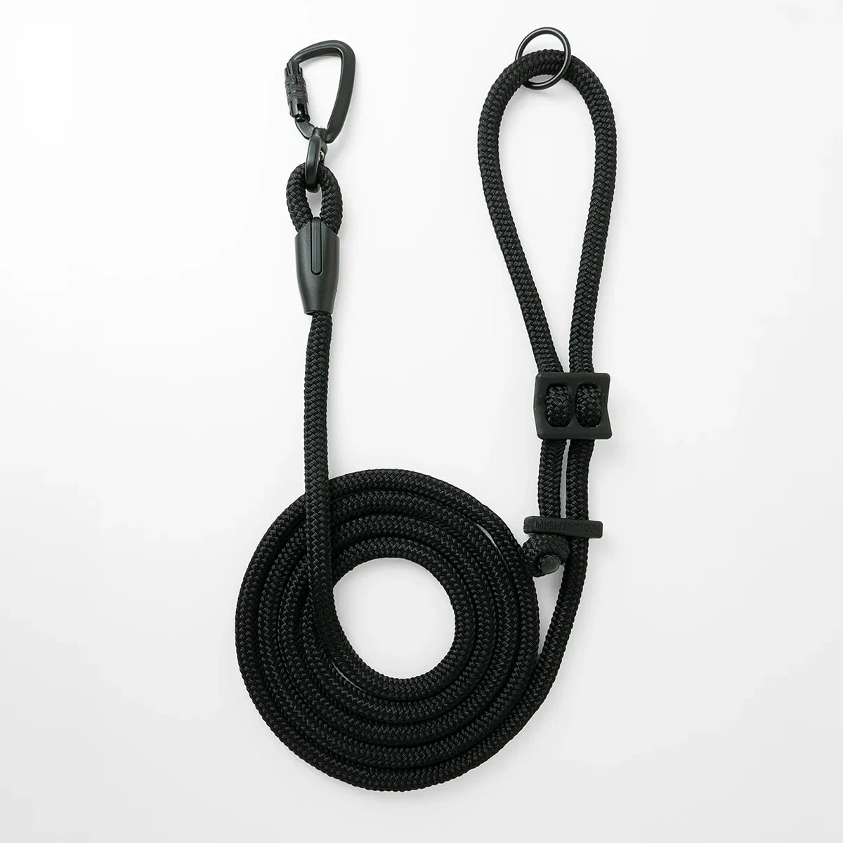 Black hands-free dog leash by Mighty Tiga, rolled for display on white background