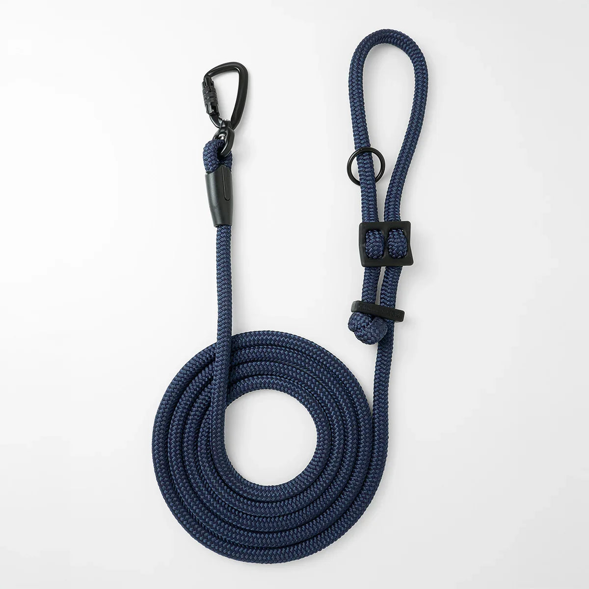 Hands-free dog leash in navy blue by Mighty Tiga, rolled for display on white background