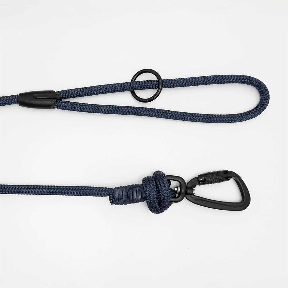 Detail view of long line dog training lead handle with black swivel carabiner and black O-ring hardware, shown in navy blue on white background