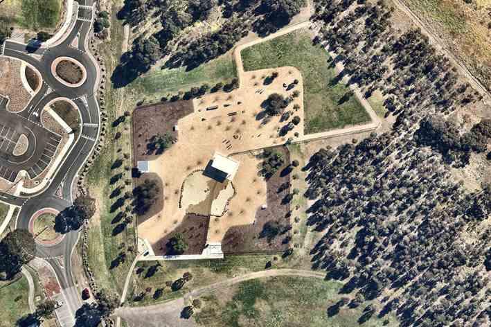 Aerial view of a fenced-off dog park in Melbourne with open grassy space for dogs to play