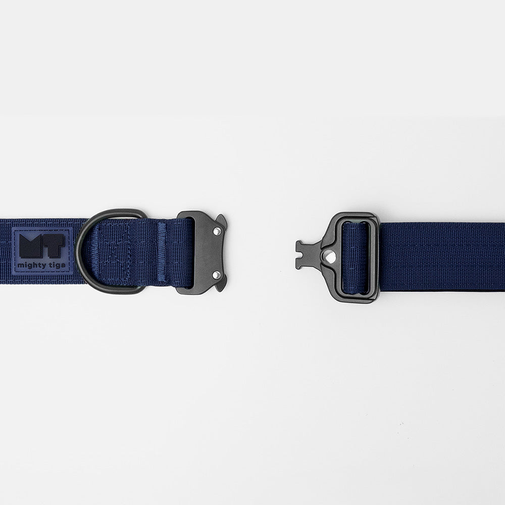 Tactical dog collar with black metal buckle on a white background, featuring the 'Mighty Tiga' logo