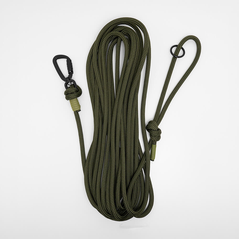 army green rope long dog lead - dog long line coiled on a white background