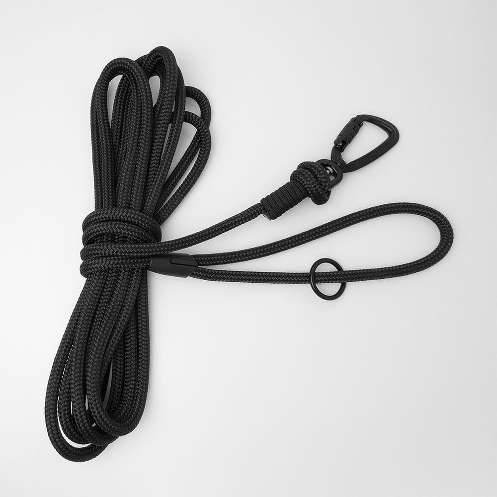 Black 5m long dog lead with a black carabiner and black O-ring on a white background