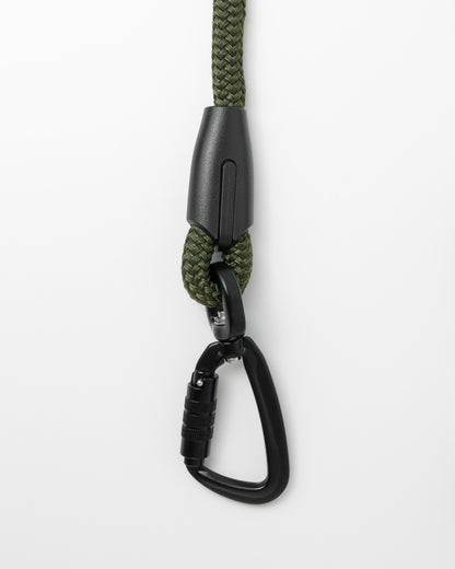 close up of swivel carabiner of army green handsfree leash