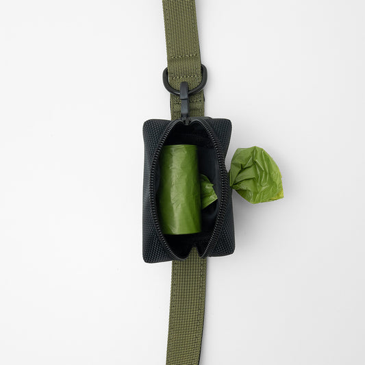 dog poop bag holder with one poop bag roll, attached to leash with clip and velcro straps