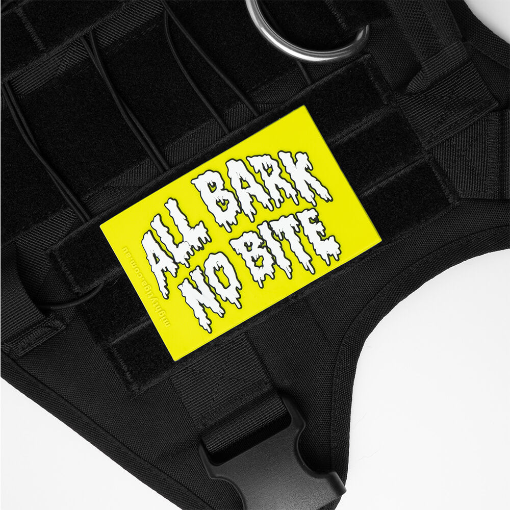 Black dog harness with a lime green patch featuring 'All Bark No Bite' text.