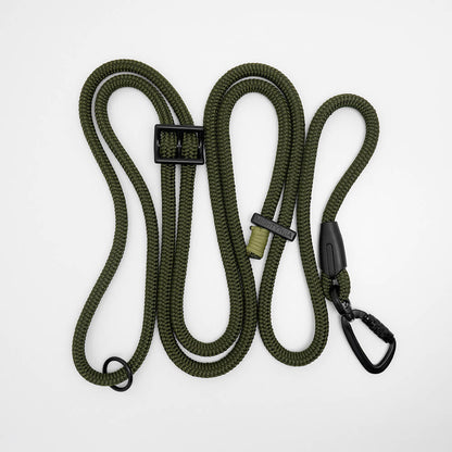 Green hands free dog leash coiled, showing adjustable rope lead with carabiner and whipping detail