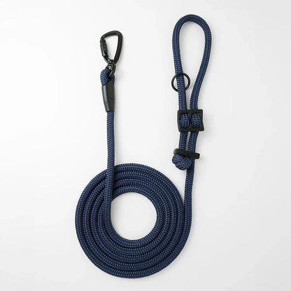 Navy blue hands-free dog leash by Mighty Tiga, rolled for display on white background