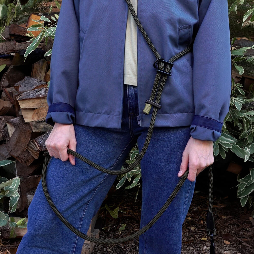 person wearing the hands-free dog leash around shoulders