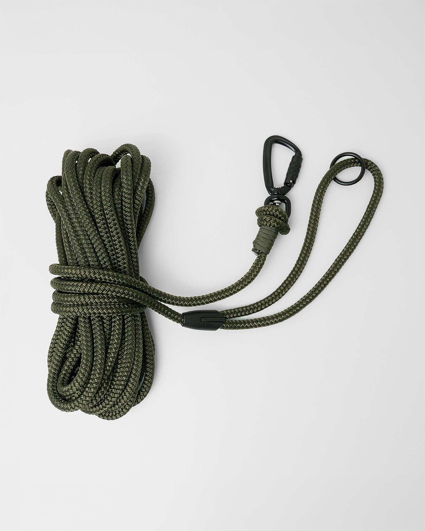 Army green long line dog training lead featuring black swivel carabiner and black O-ring, coiled on a white background