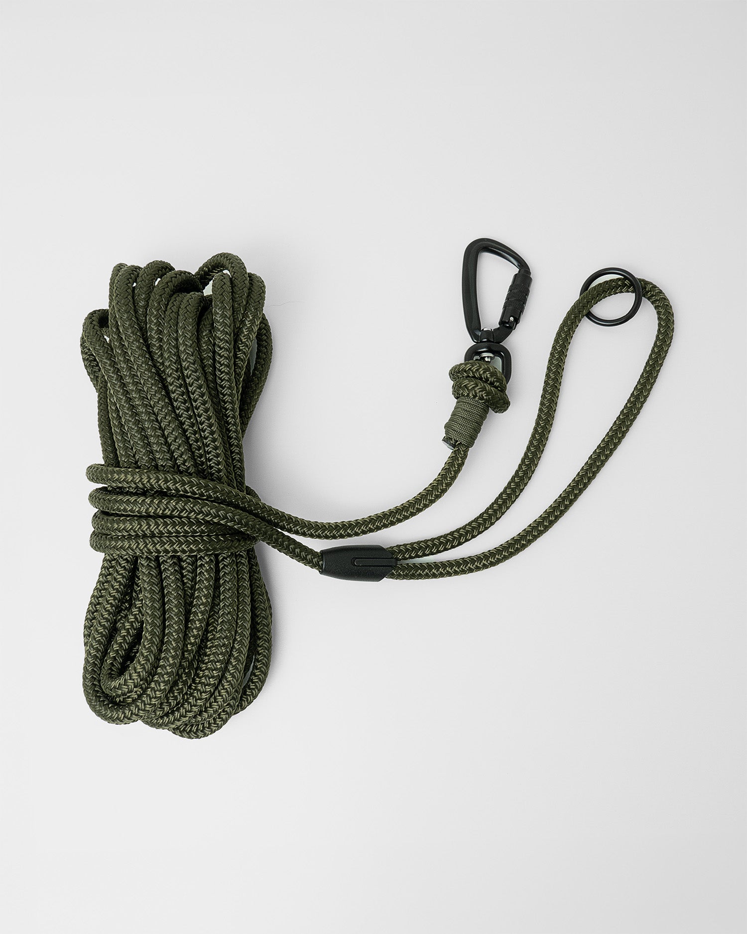 Army green long line dog training lead featuring black swivel carabiner and black O-ring, coiled on a white background