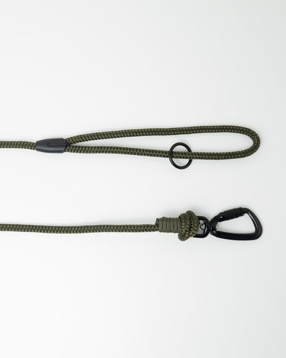 Detail view of long line dog training lead handle with black swivel carabiner and black O-ring hardware, shown in army green on white background