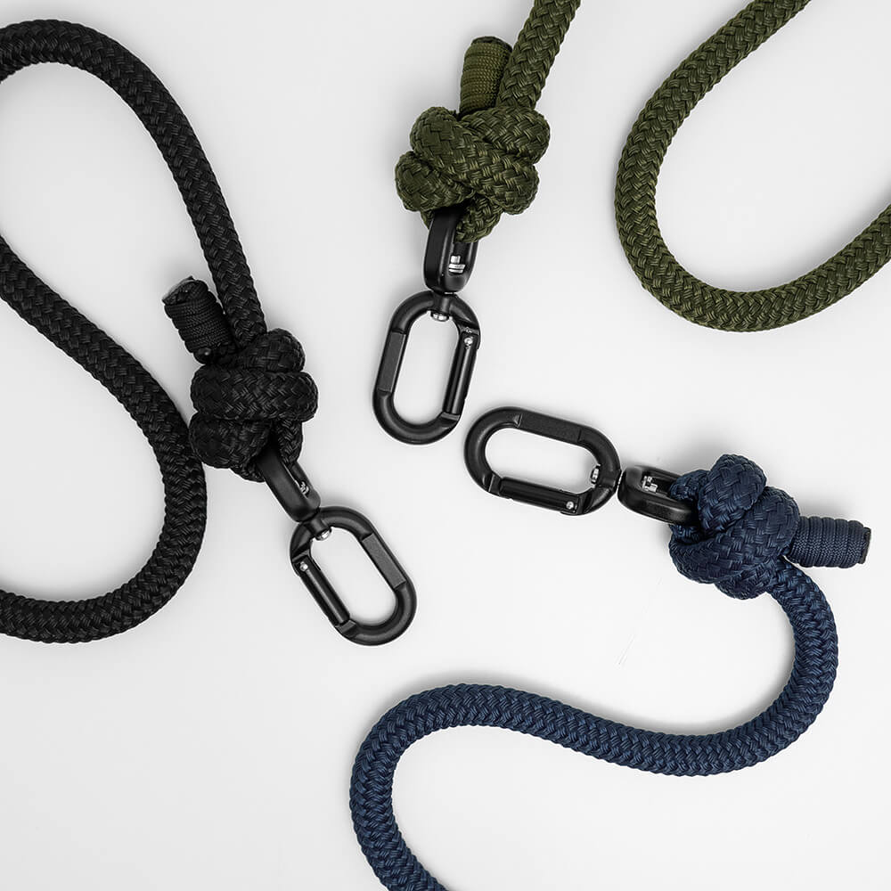 Three braided rope leashes for strong dogs in black, olive green, and navy blue, each shown with a knot and metal carabiner clip on a clean white background.