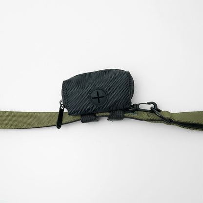 dog poop bag holder with one poop bag roll, attached to leash with clip and velcro straps